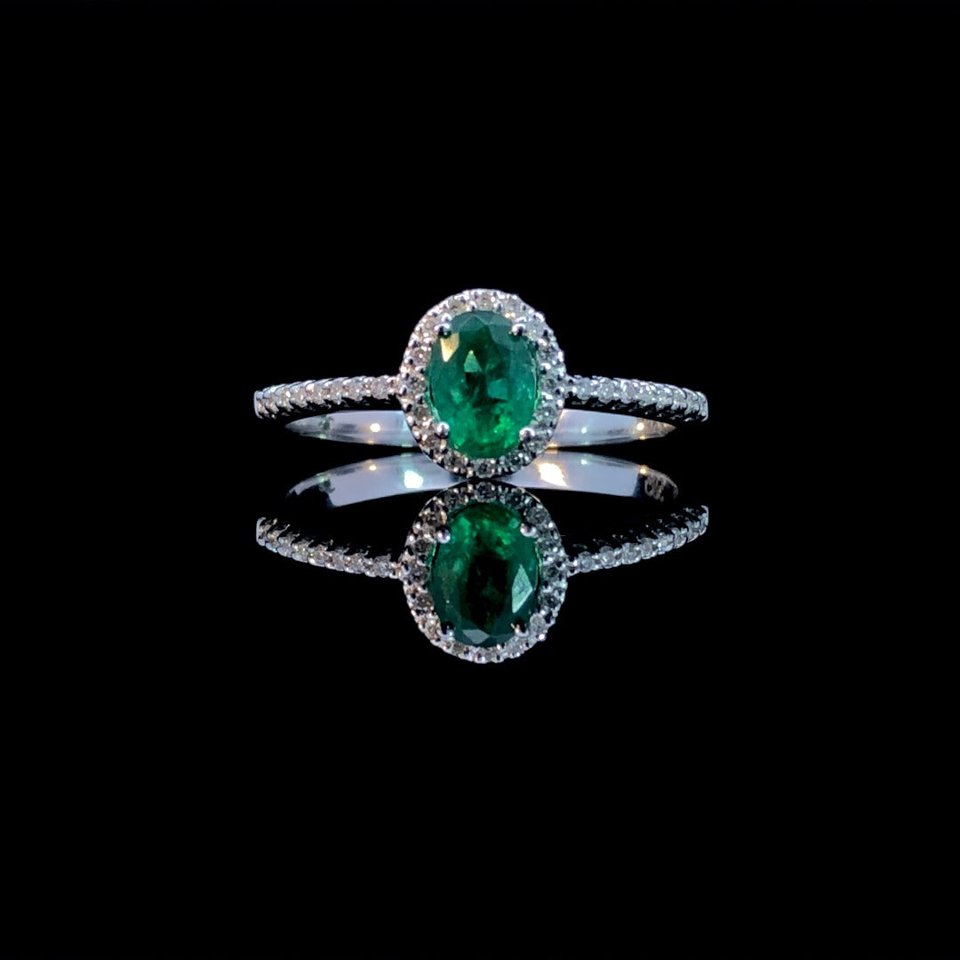 163300 - .64 ctw diamond and emerald ring